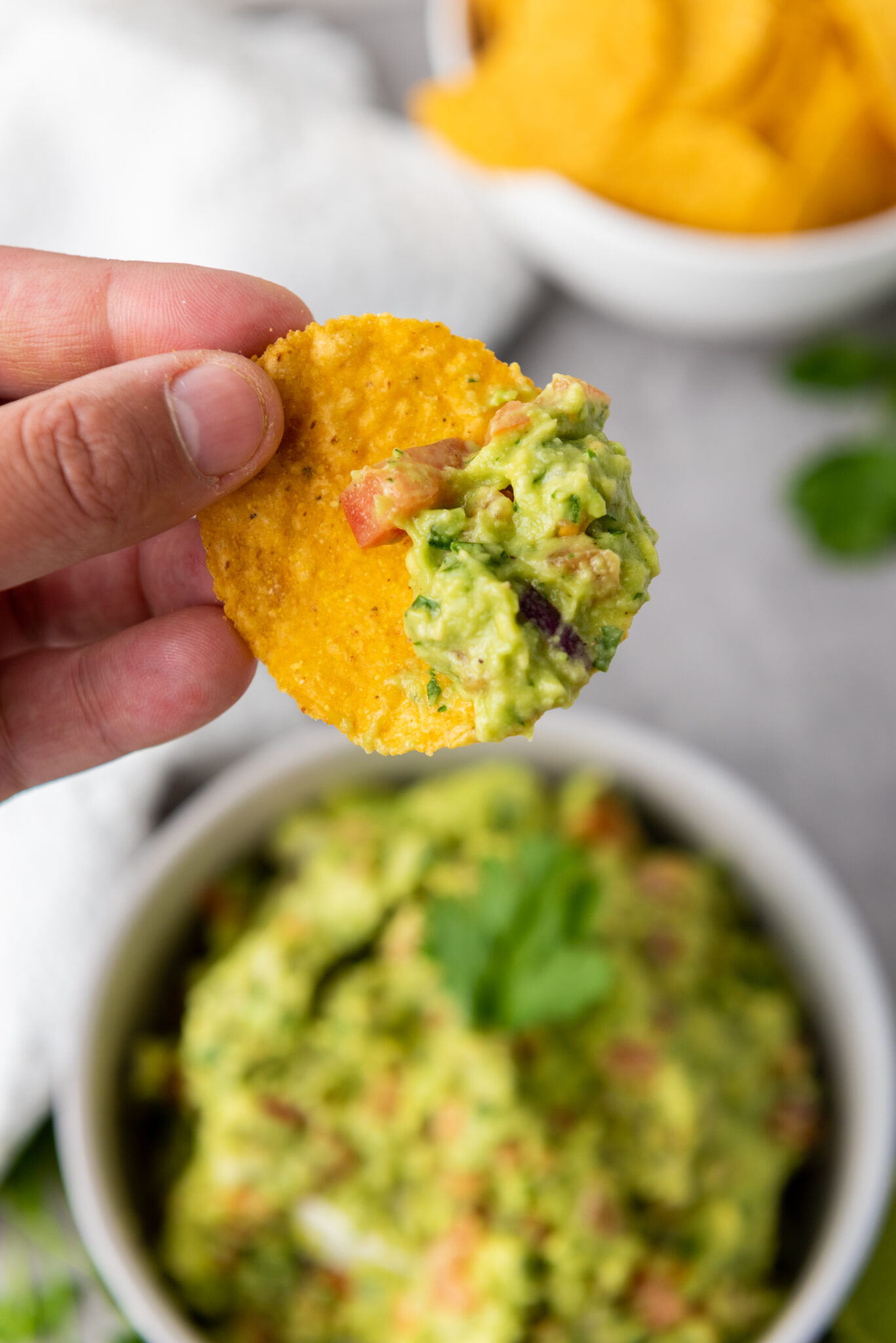 homemade guacamole eaten with a chip