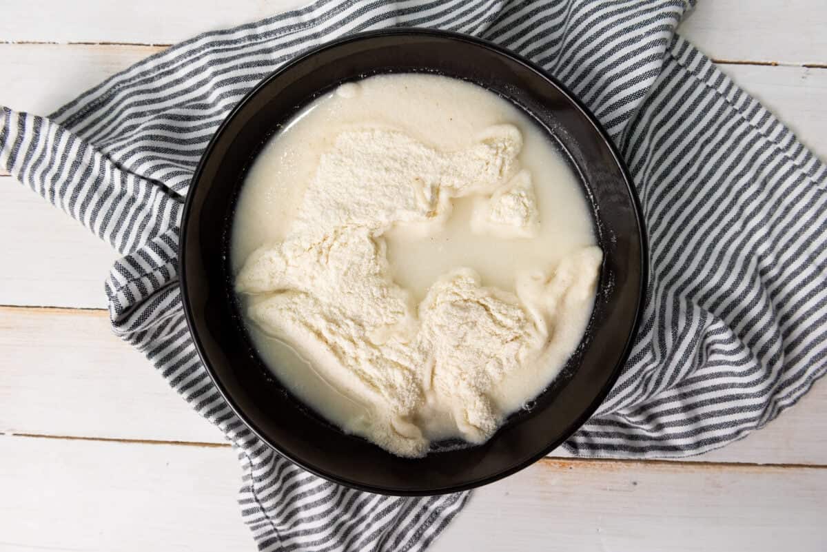 Mixing masarepa and water in a bowl