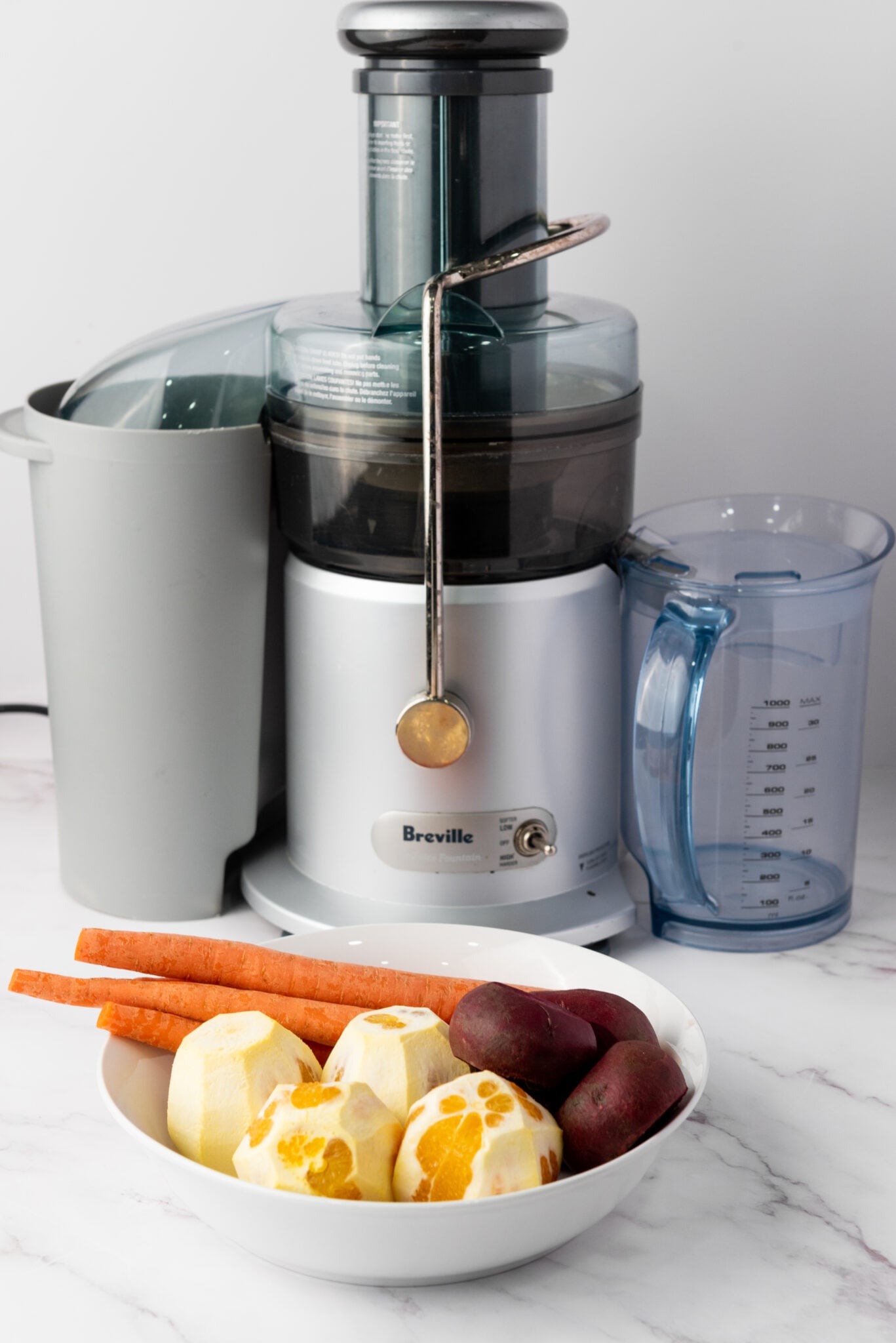 red juice ingredients in front of breville juicer
