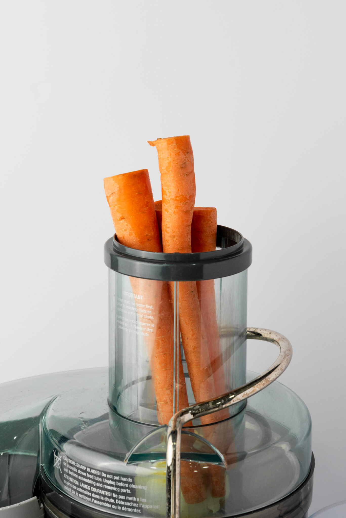adding carrots to juicer