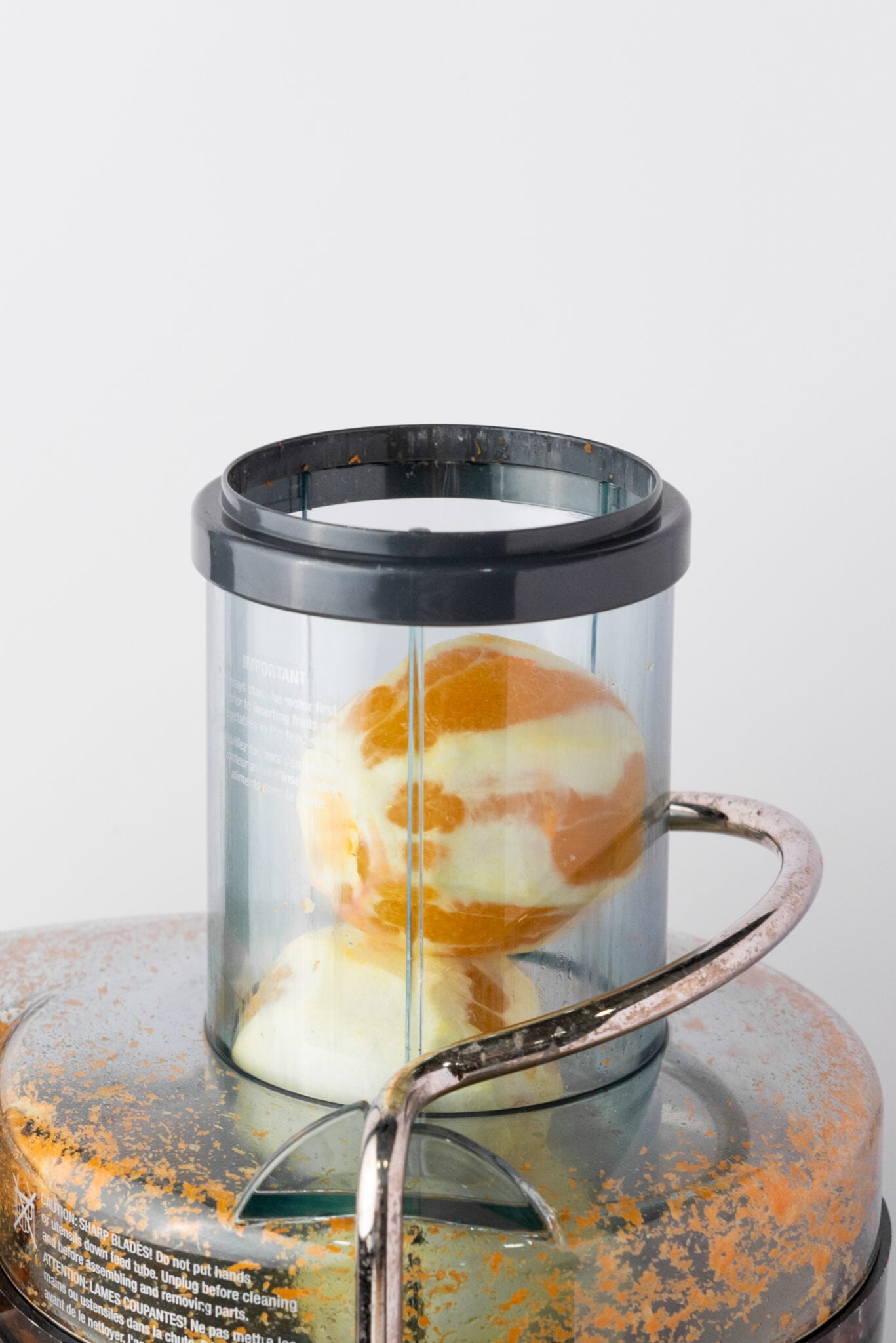 adding oranges to juice