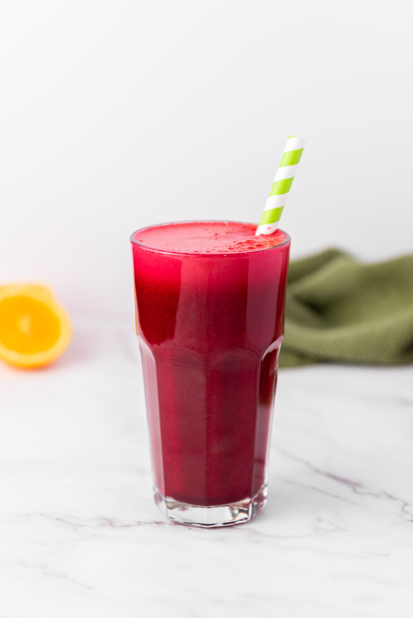 red juice in a glass with a straw