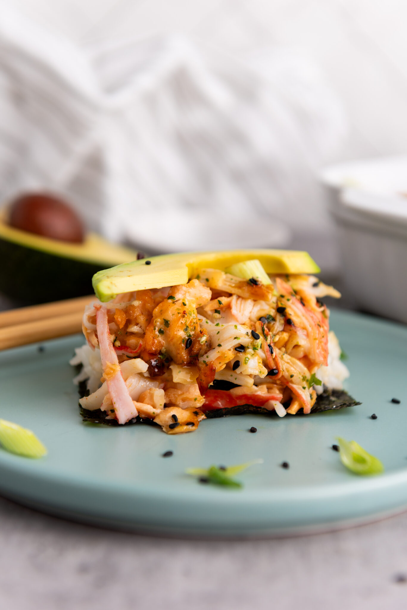 Side view of sushi bake piece on a plate ready to be enjoyed.