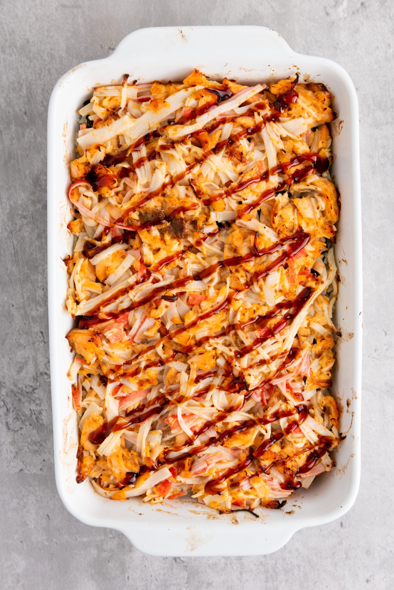 Close-up of sushi bake topped with sauces