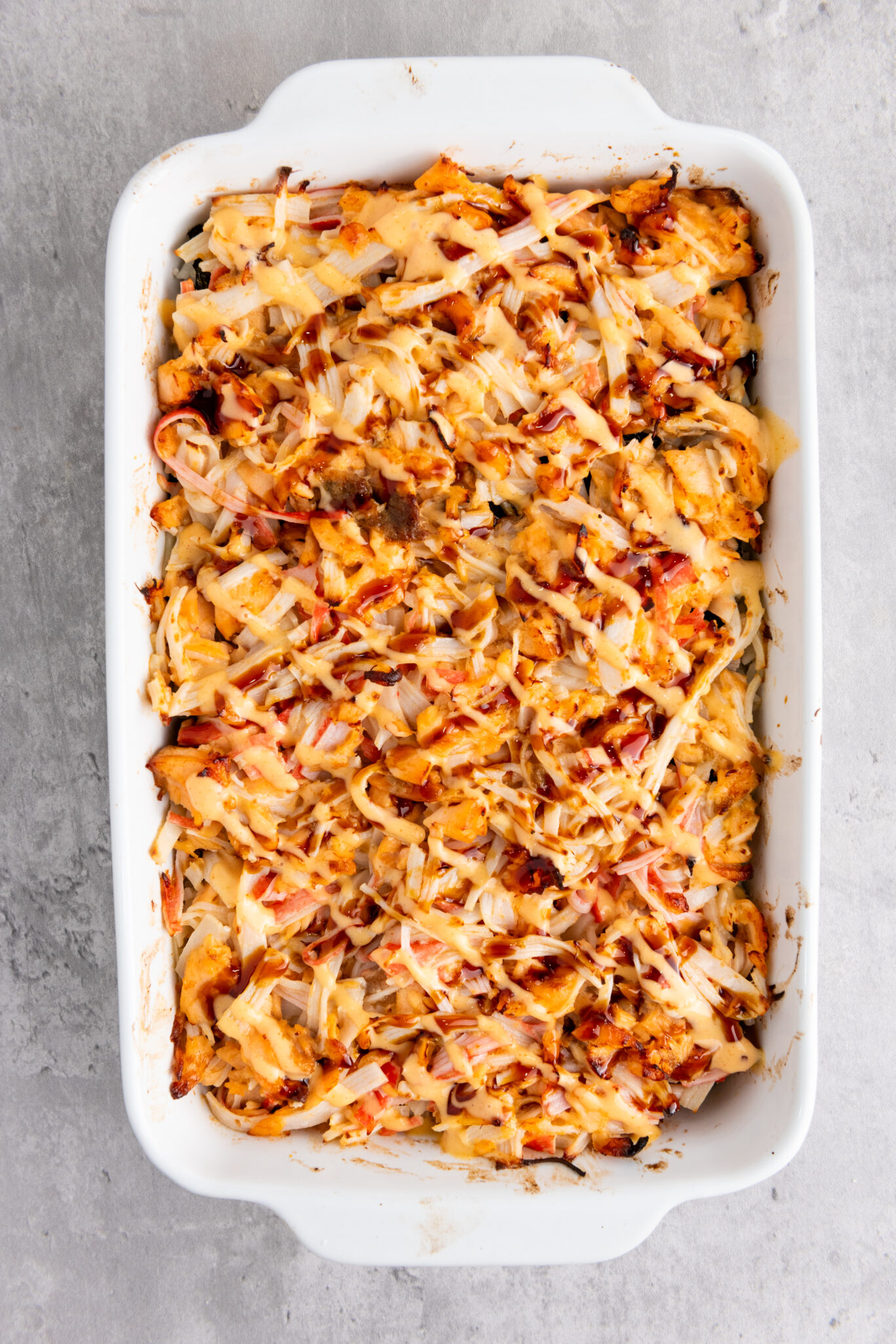 Close-up of sushi bake topped with sauces