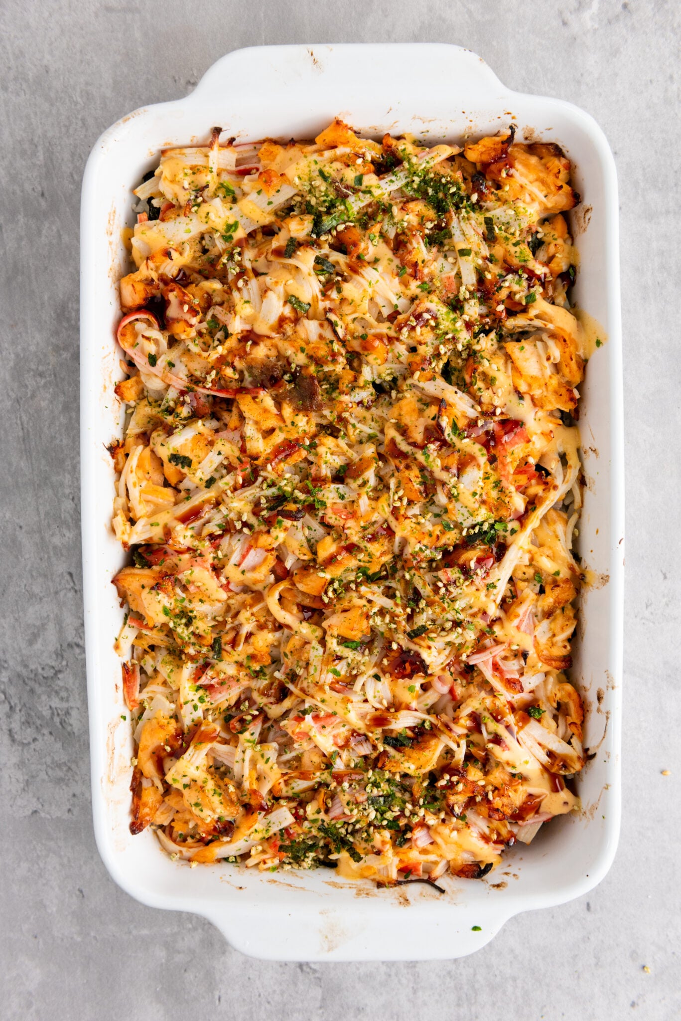 Close-up of sushi bake topped with sauces and seasonings