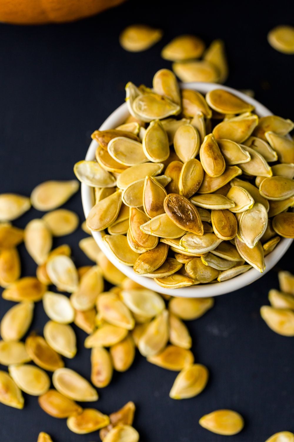 close up of pumpkin seeds in bowl