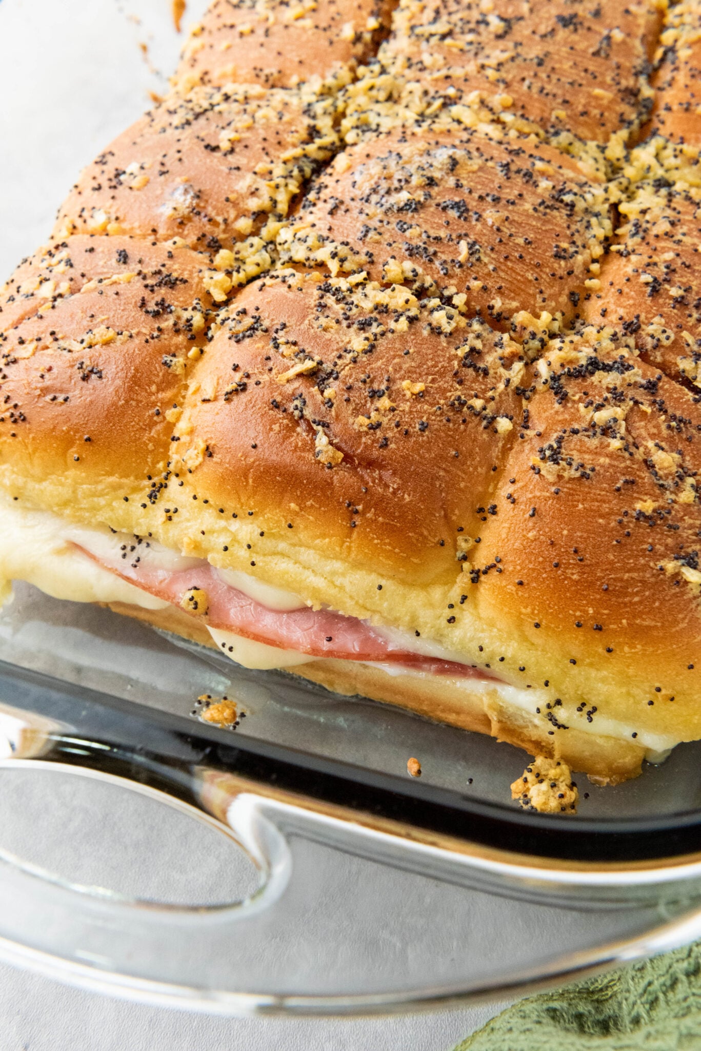 close up of hawaiian ham and cheese sliders in baking dish