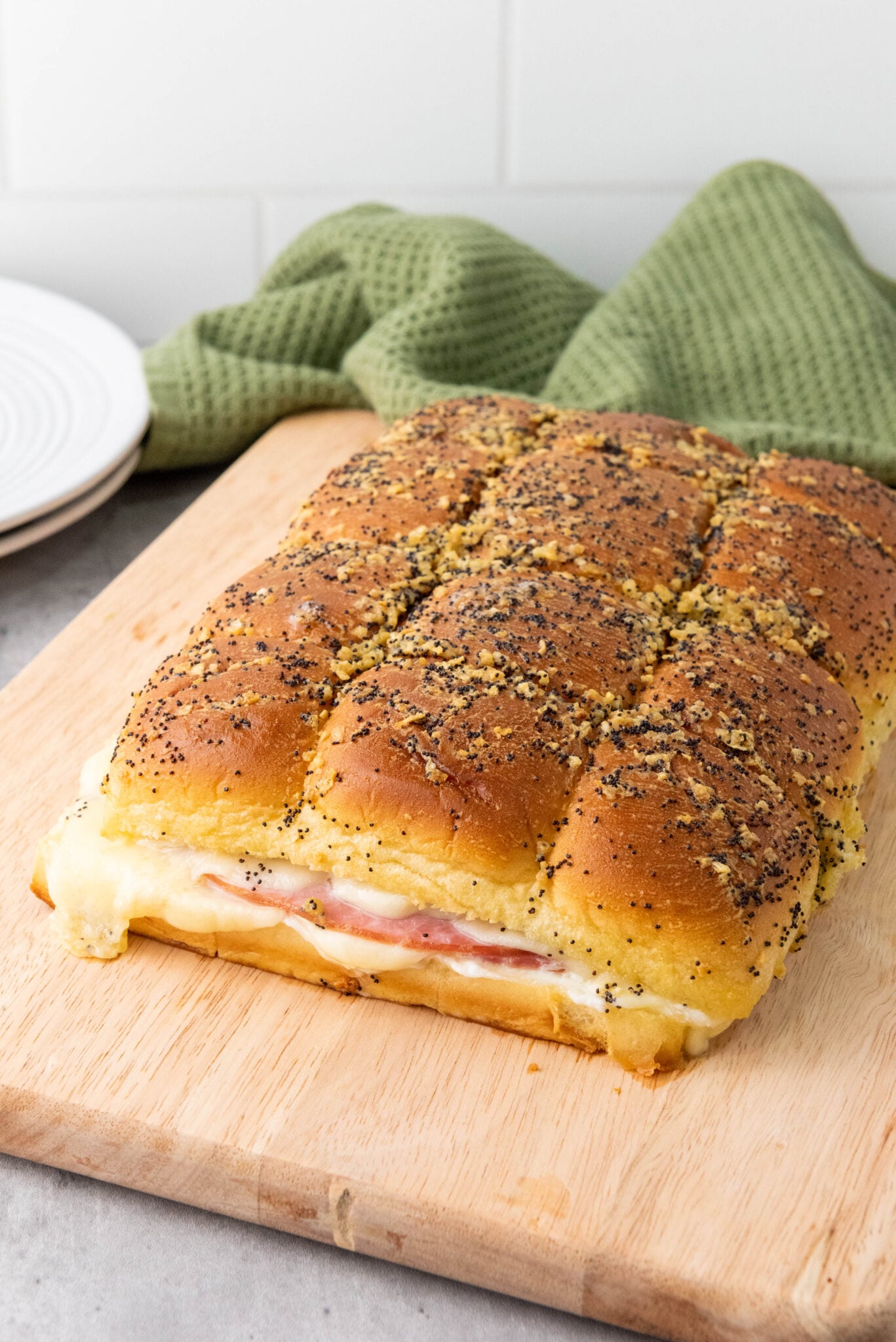 ham and cheese sliders on a cutting board