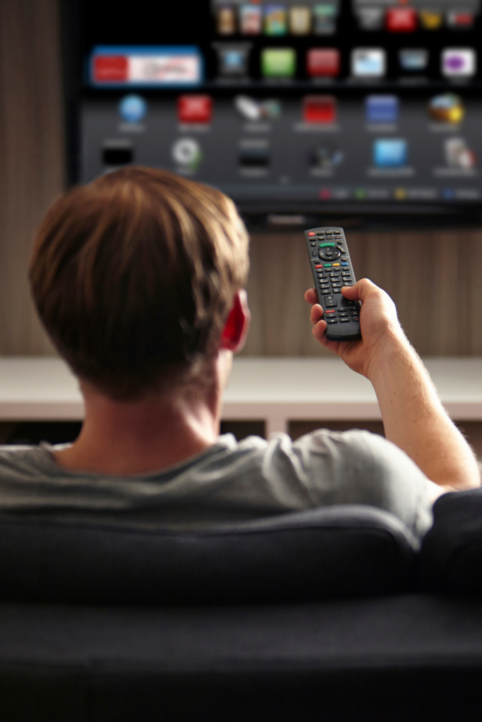 Man watching tv with his vidangel free trial