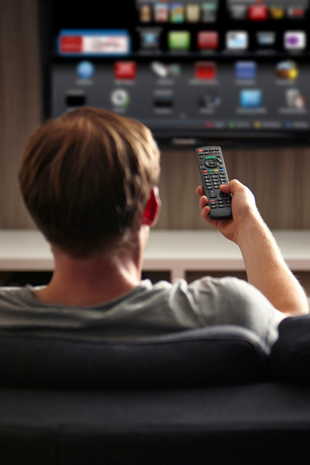 Man watching tv with his vidangel free trial