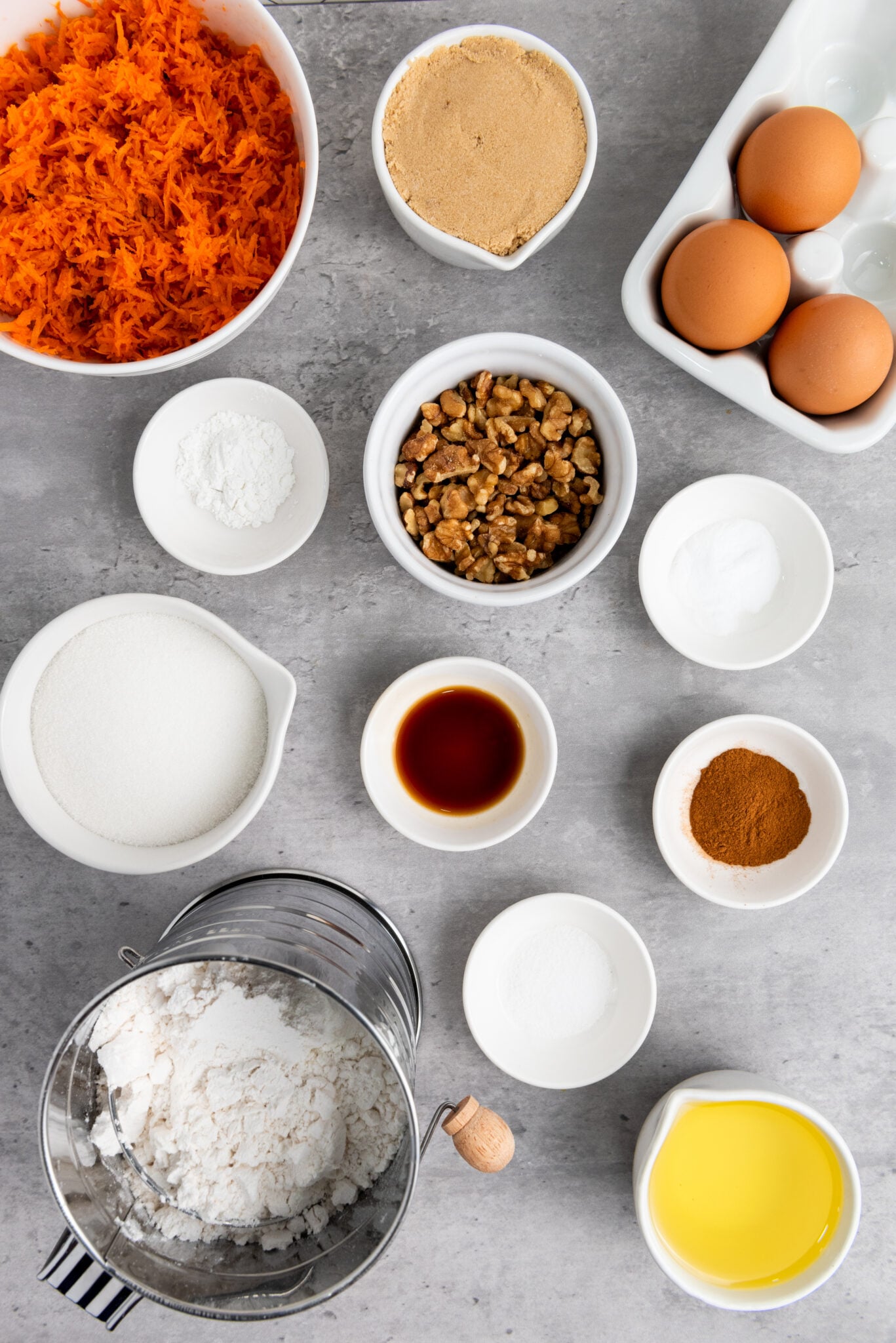 Assorted baking ingredients laid out on a kitchen counter, ready for making Carrot Cake Cupcakes.