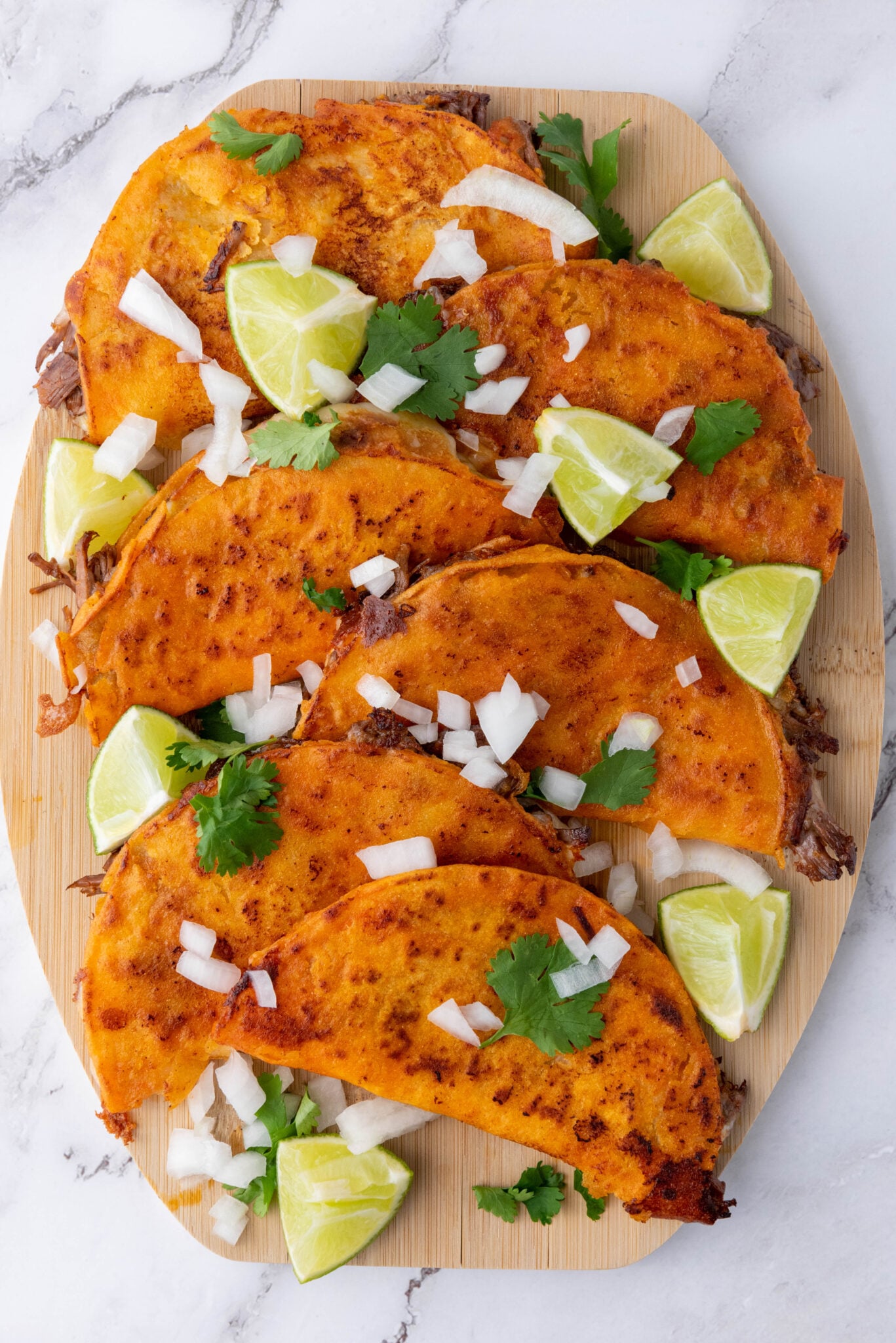 stack of birria de res tacos