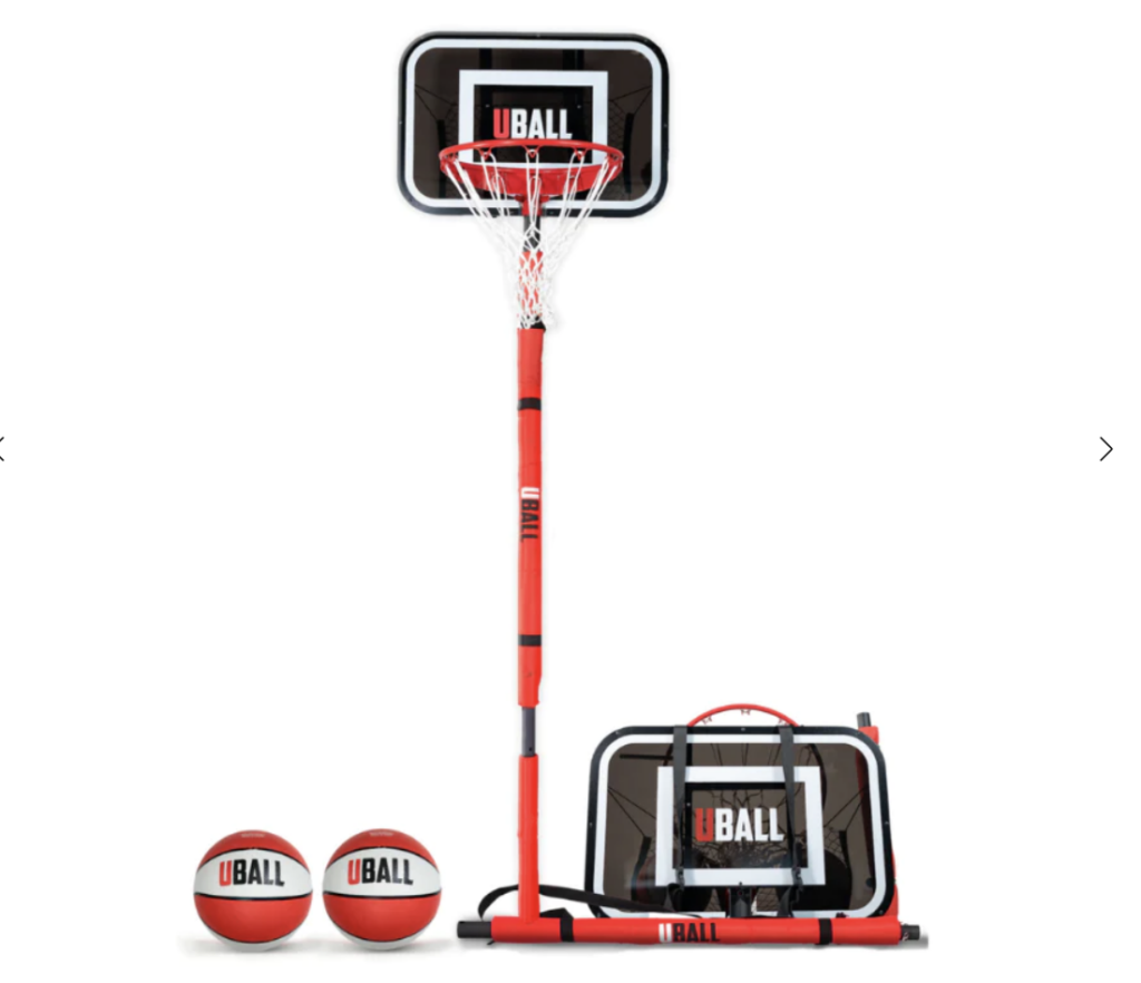 Portable basketball hoop with adjustable pole, red and black base with wheels, and two basketballs on the side.