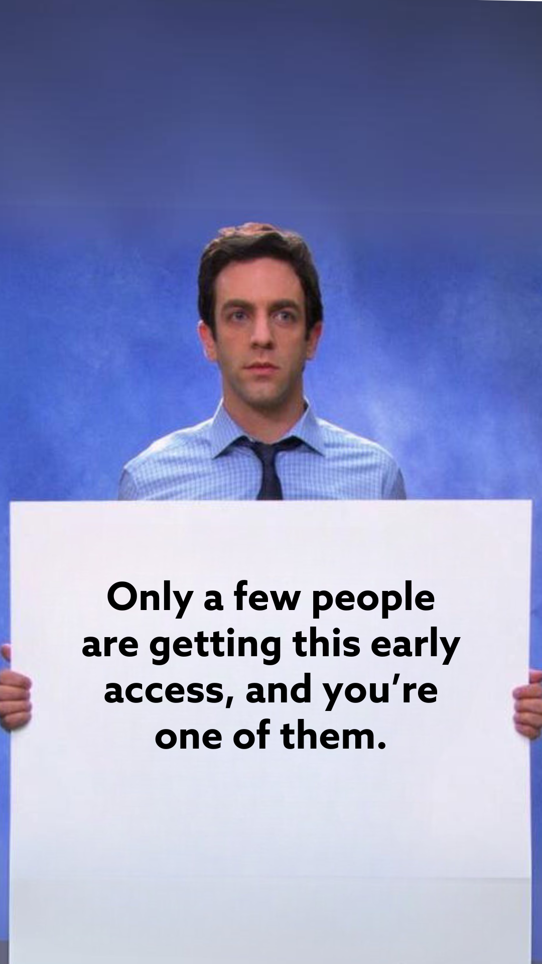 A person holds a sign that reads, "Only a few people are getting this early access, and you're one of them. Exclusive Black Friday promo codes inside!