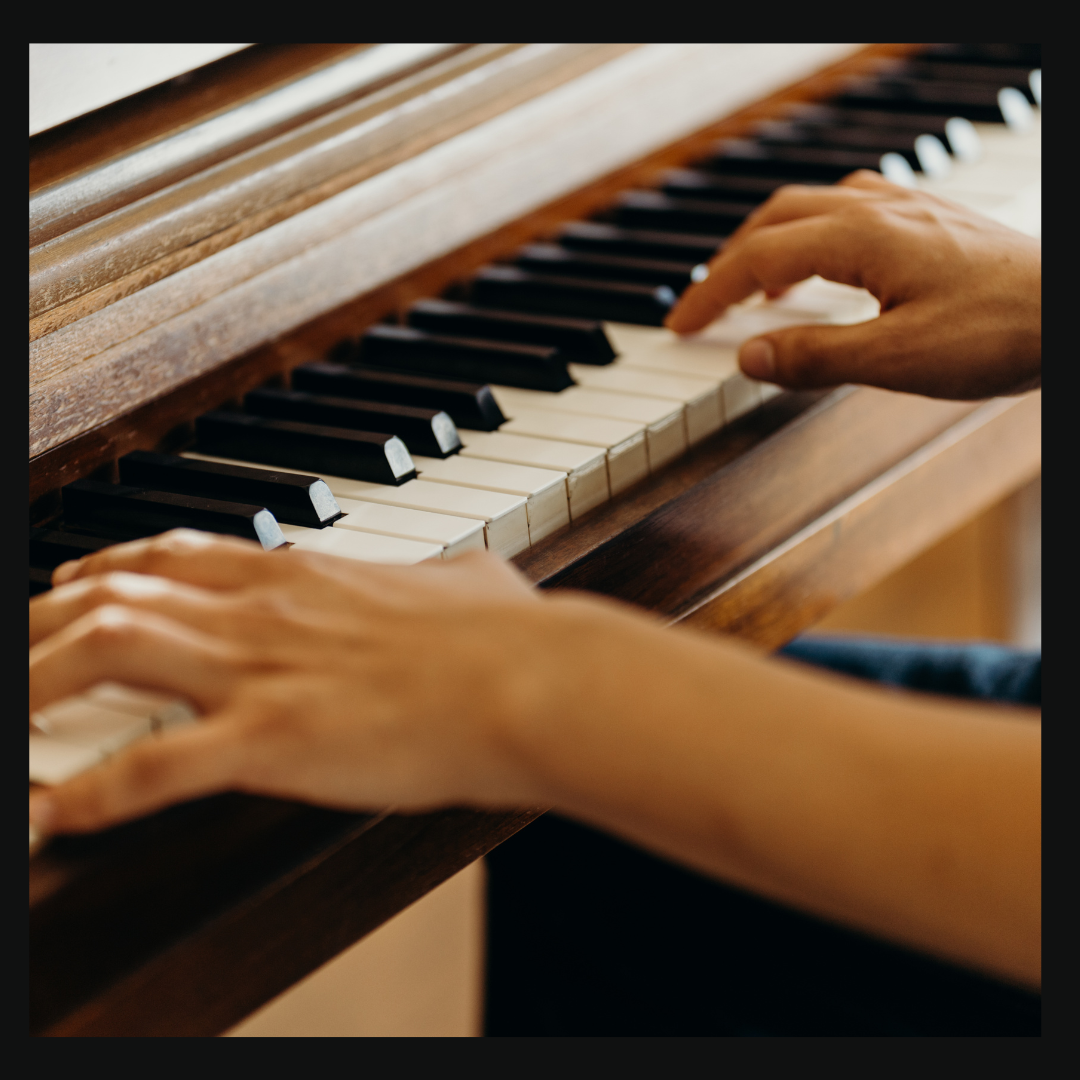 Hands gracefully dancing over piano keys, with the elegant wood paneling softly gleaming. Dive into this musical journey with a 14-day free trial and discover your own symphony waiting to emerge from those classic keys.