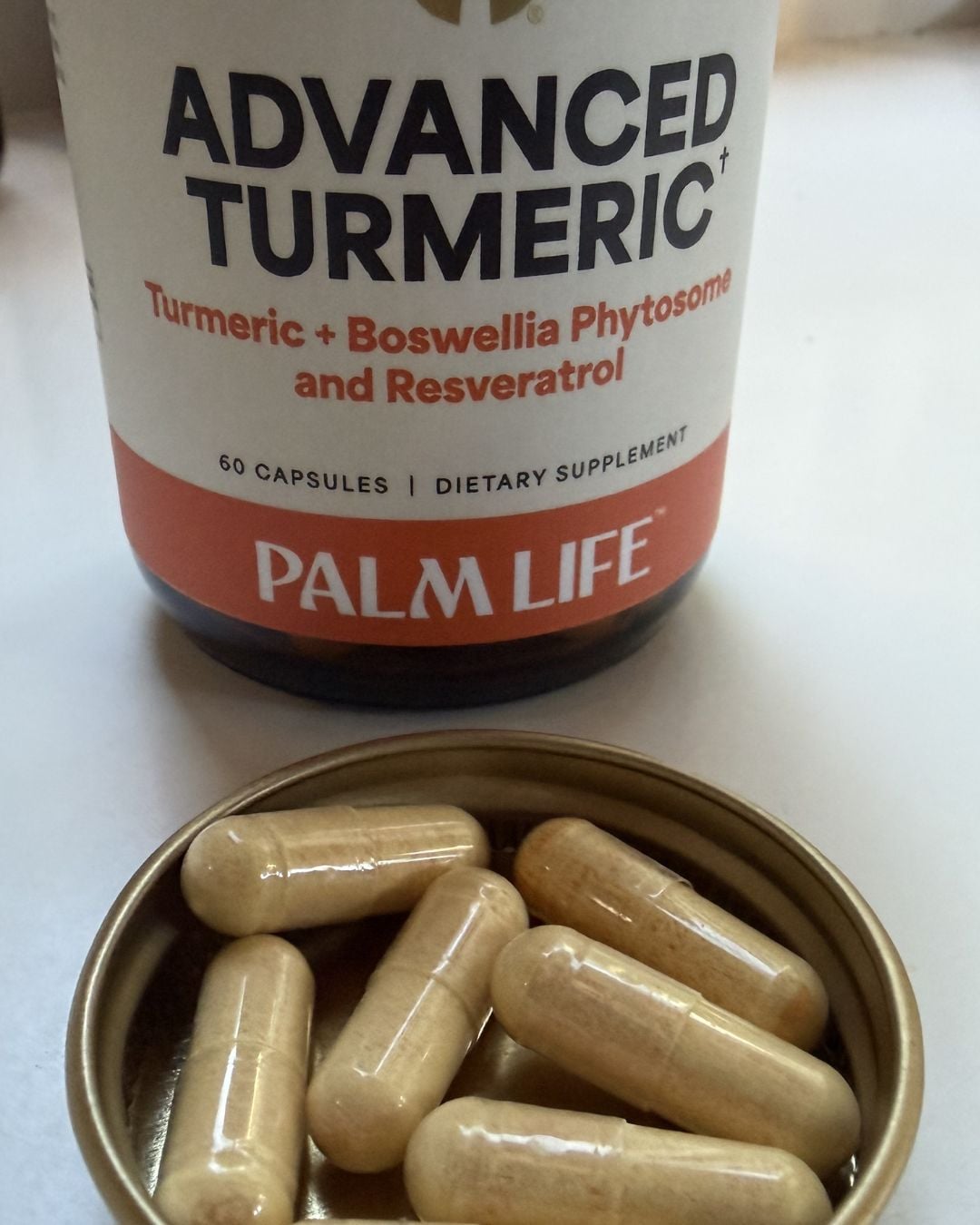 Palm Life Advanced Turmeric supplement with capsules displayed in front of the bottle