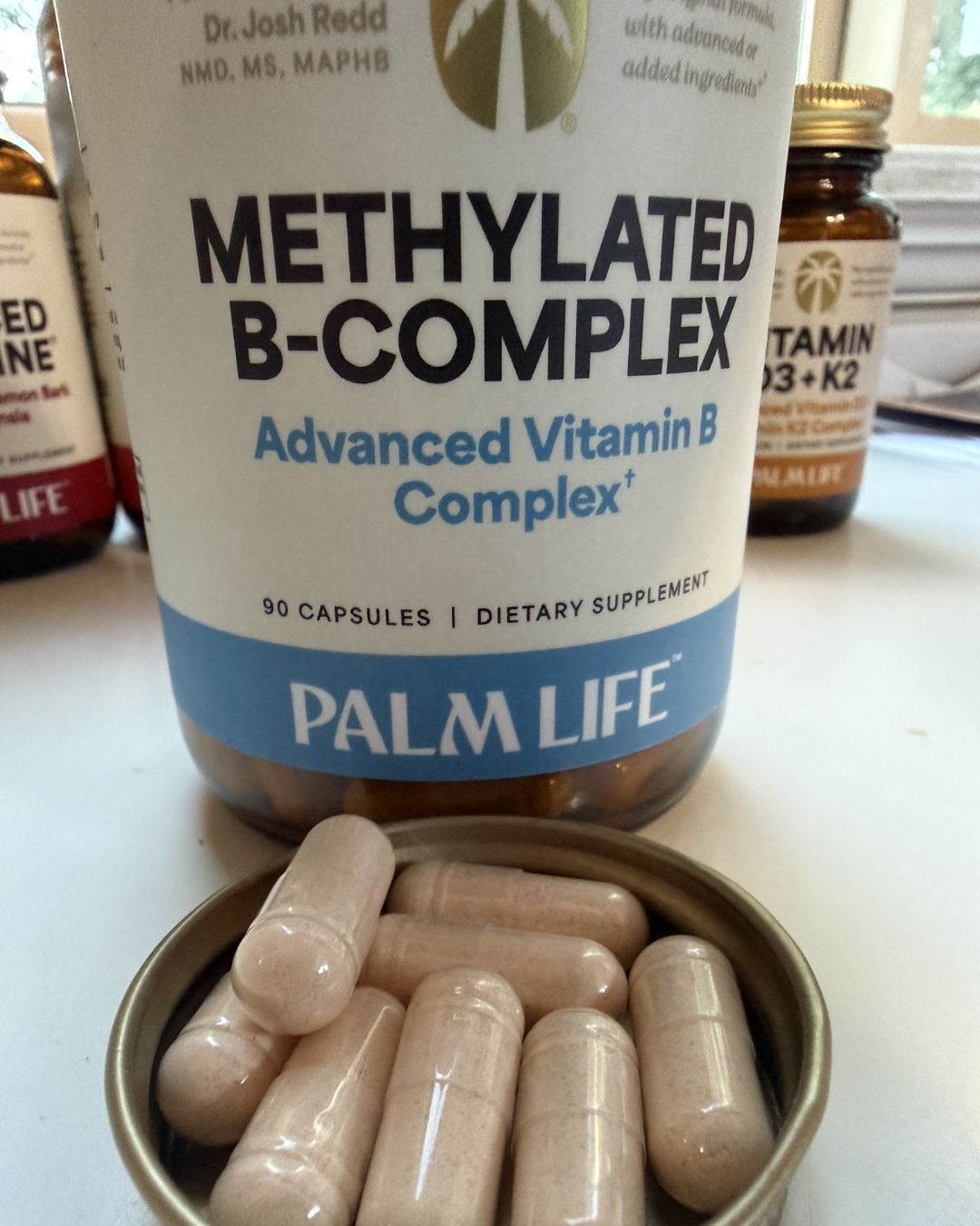 Palm Life Methylated B-Complex supplement with capsules in front of the bottle