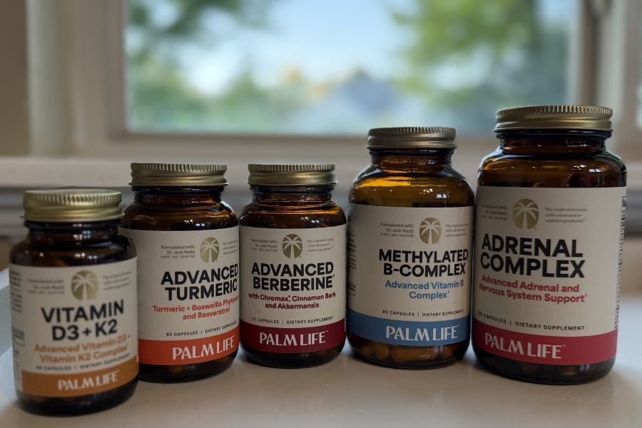 Palm Life supplements including Vitamin D3 + K2, Advanced Turmeric, Advanced Berberine, Methylated B-Complex, and Adrenal Complex bottles arranged together.