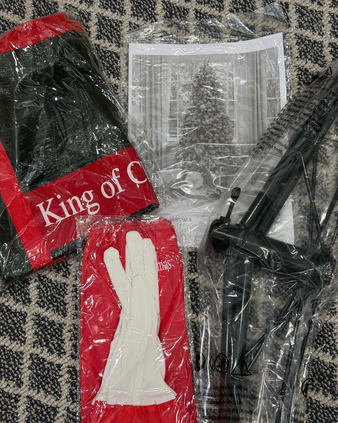 King of Christmas tree accessories including a storage bag, protective gloves, folding metal stand, and instruction manual.